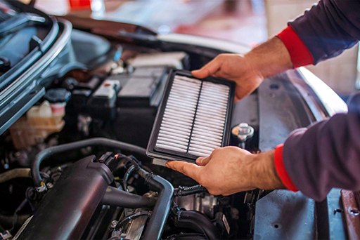 Mechanic hand checking and fixing a broken car in car service garage